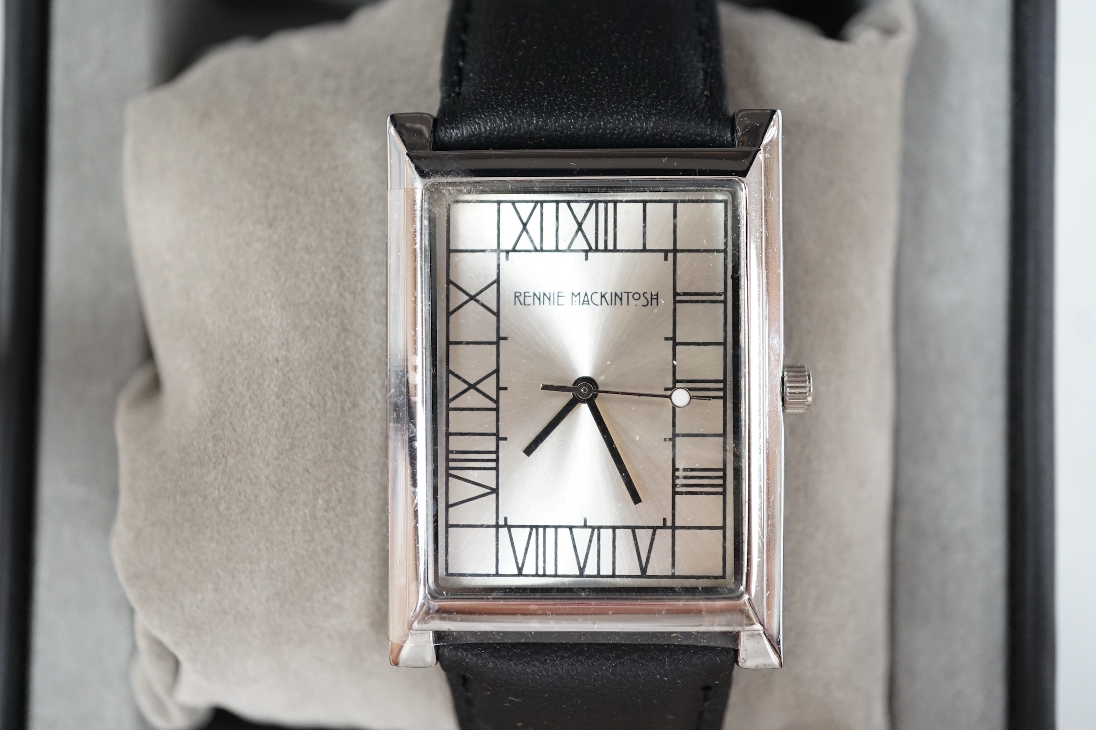 A gentleman's modern stainless steel 'Rennie Mackintosh' quartz square dial wrist watch, with original box and pamphlets.